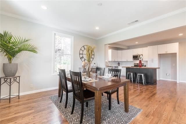 Wooden dining table with kitchen