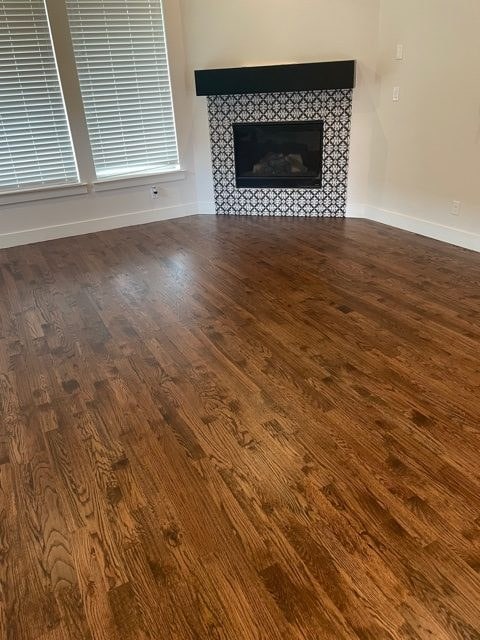 dark hardwood flooring with black and white patterned fireplace