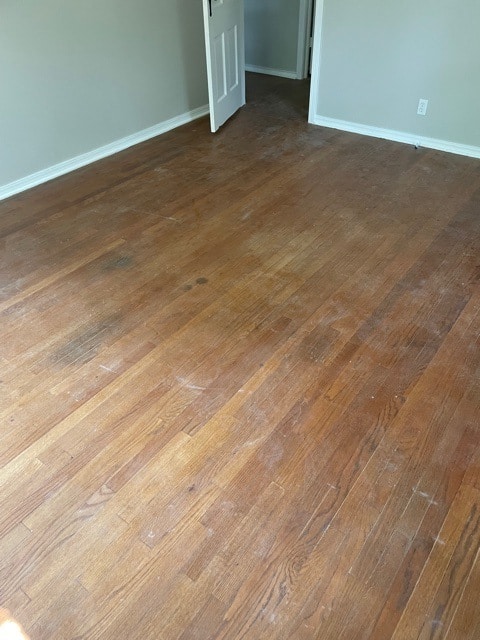 scuffed dark hardwood flooring