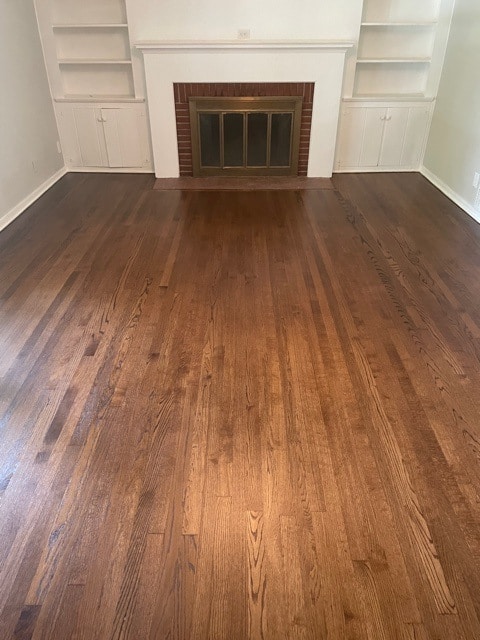 dark hardwood flooring install with fireplace