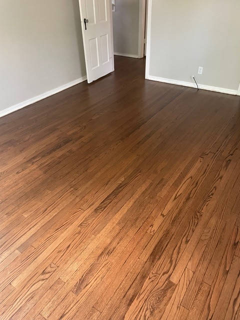 dark hardwood flooring with open door