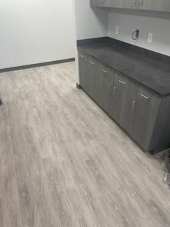 grey hardwood flooring and cabinets against wall